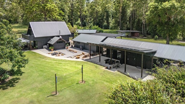 A modern house with a large patio area, a covered outdoor seating area, and a garage. - Unique rural cabin, 5 minutes from beach (Valla)
