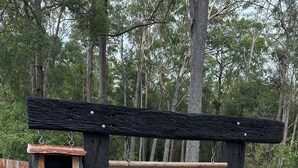 A wooden sign with a rustic design, indicating a guest house named 'Tallowwood Terrace' with addresses 38a and 38b. - Unique rural cabin, 5 minutes from beach (Valla)