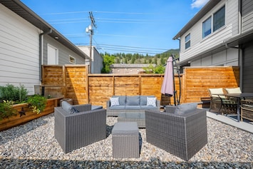 Fully fenced backyard with outdoor seating and a year-round BBQ.