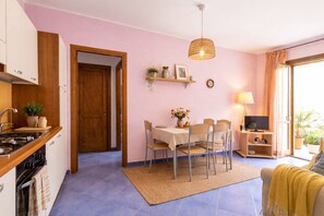 A compact living space with a kitchen, dining area, and a TV.