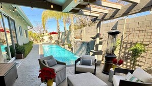 A backyard with a pool, outdoor furniture, and string lights. - Arcadia Bright and Cheery House (Phoenix)
