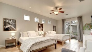 A bedroom with two beds, a ceiling fan, and artwork on the walls. - Arcadia Bright and Cheery House (Phoenix)