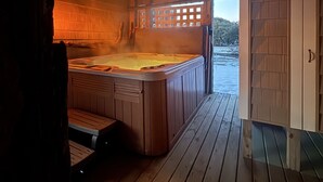 A wooden hot tub in a cabin with a wooden deck and a view of the outdoors. - 4x4 Carova, WaterFront, Dock, Wild Horses, Hot Tub (Corolla)