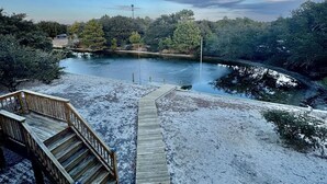 A wooden deck leading to a river with a clear sky and trees in the background. - 4x4 Carova, WaterFront, Dock, Wild Horses, Hot Tub (Corolla)