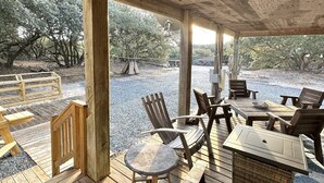 A covered outdoor seating area with wooden furniture, a table, and chairs. - 4x4 Carova, WaterFront, Dock, Wild Horses, Hot Tub (Corolla)