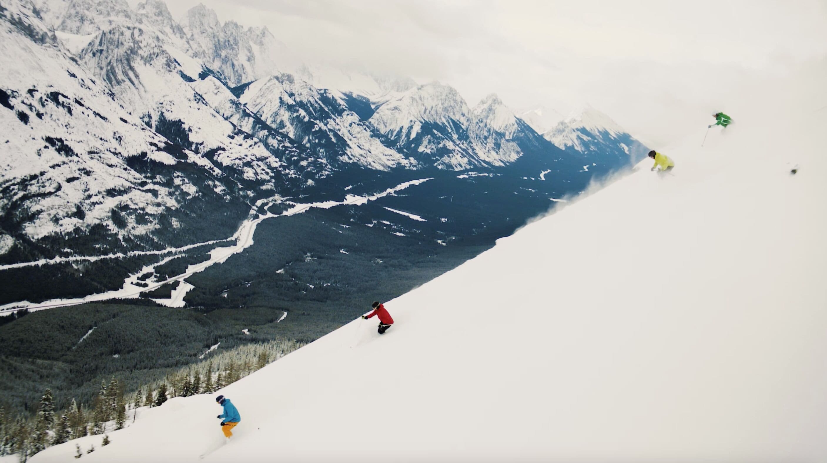A snowy mountain landscape with a clear path for skiing.