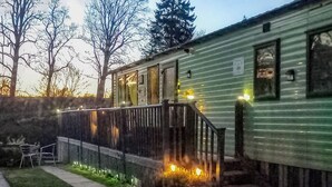 A small, single-story building with a porch and a staircase leading to the entrance. - 3 bedroom accommodation in Hawick (Hawick)