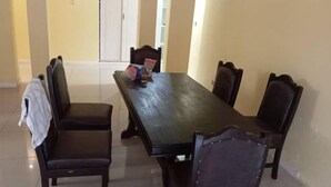 A dining area with a rectangular table and six chairs. - New California  (Lilongwe)
