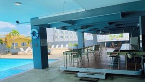 An outdoor pool area with a bar and seating.