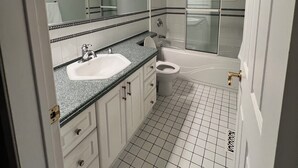 A bathroom with a sink, toilet, and bathtub.