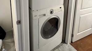 A laundry room with two stacked front-loading washing machines.