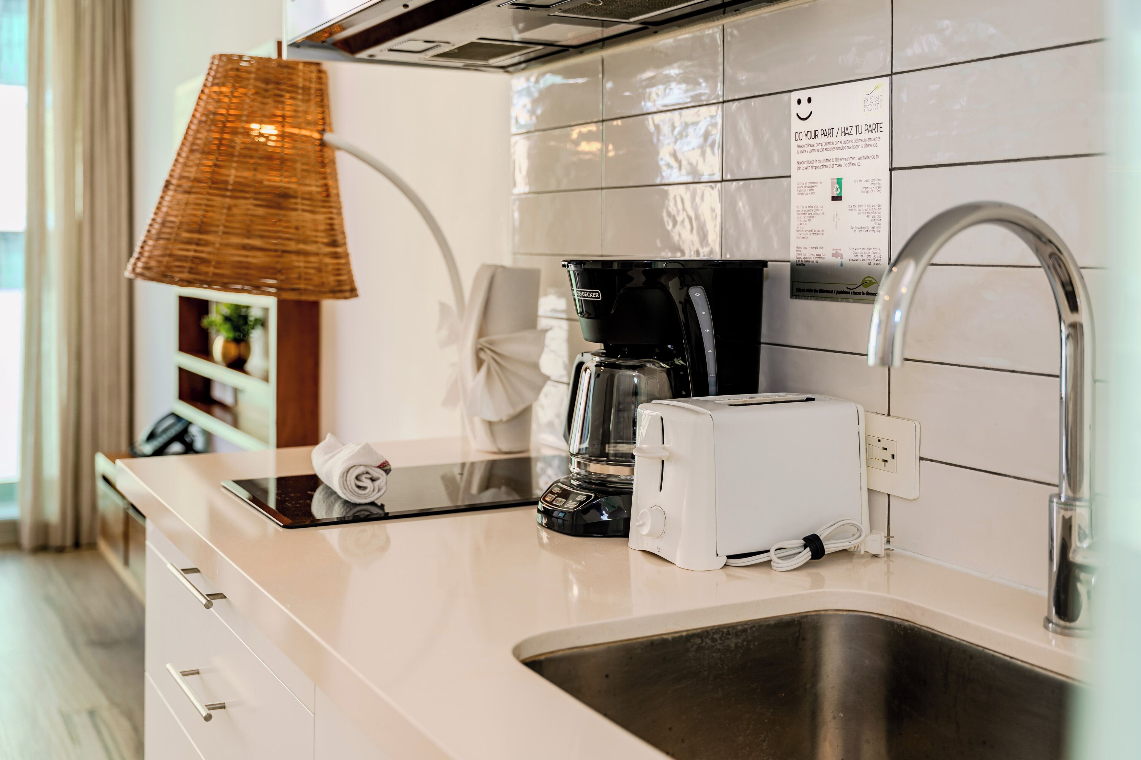 A modern kitchen with a coffee maker, toaster, and a sink.