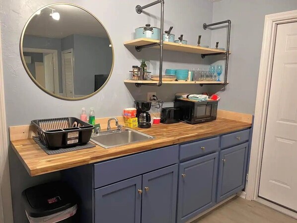 Fridge, coffee/tea maker, toaster, cookware/dishes/utensils