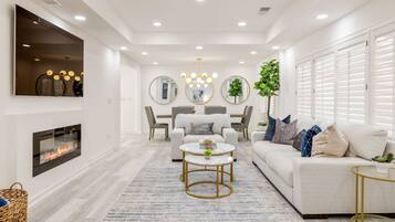 Smart TV, fireplace, books, computer monitors