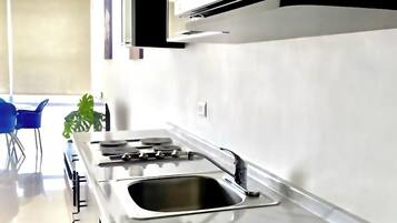 Microwave, stovetop, coffee/tea maker, cookware/dishes/utensils