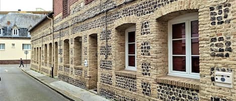 A historic stone building with arched windows and a brick facade.