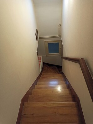 Stairs lead upwards to a small window.