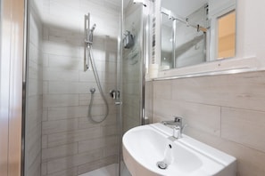 Shower, hair dryer, towels, shampoo