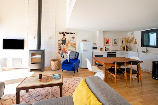 A modern living room with a sofa, coffee table, and a fireplace.