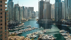 A marina with numerous boats docked, surrounded by high-rise buildings. - Silkhaus Al Mass (Dubai)