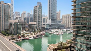 A marina with boats, surrounded by high-rise buildings with modern architecture. - Silkhaus Marina Quays West (Dubai)