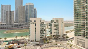 A high-rise hotel with multiple floors, a beach view, and a marina in the background. - Silkhaus Reflection Tower (Abu Dhabi)