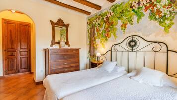Una camera da letto con un letto, un armadio in legno e un muro decorato con un murale floreale.