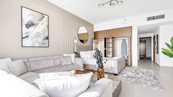 A modern living room with a sectional sofa, a coffee table, and a large abstract painting.