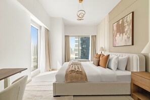A modern hotel room with a large bed, a desk, and a view of the cityscape. - Silkhaus Gate Tower 2 (Abu Dhabi)