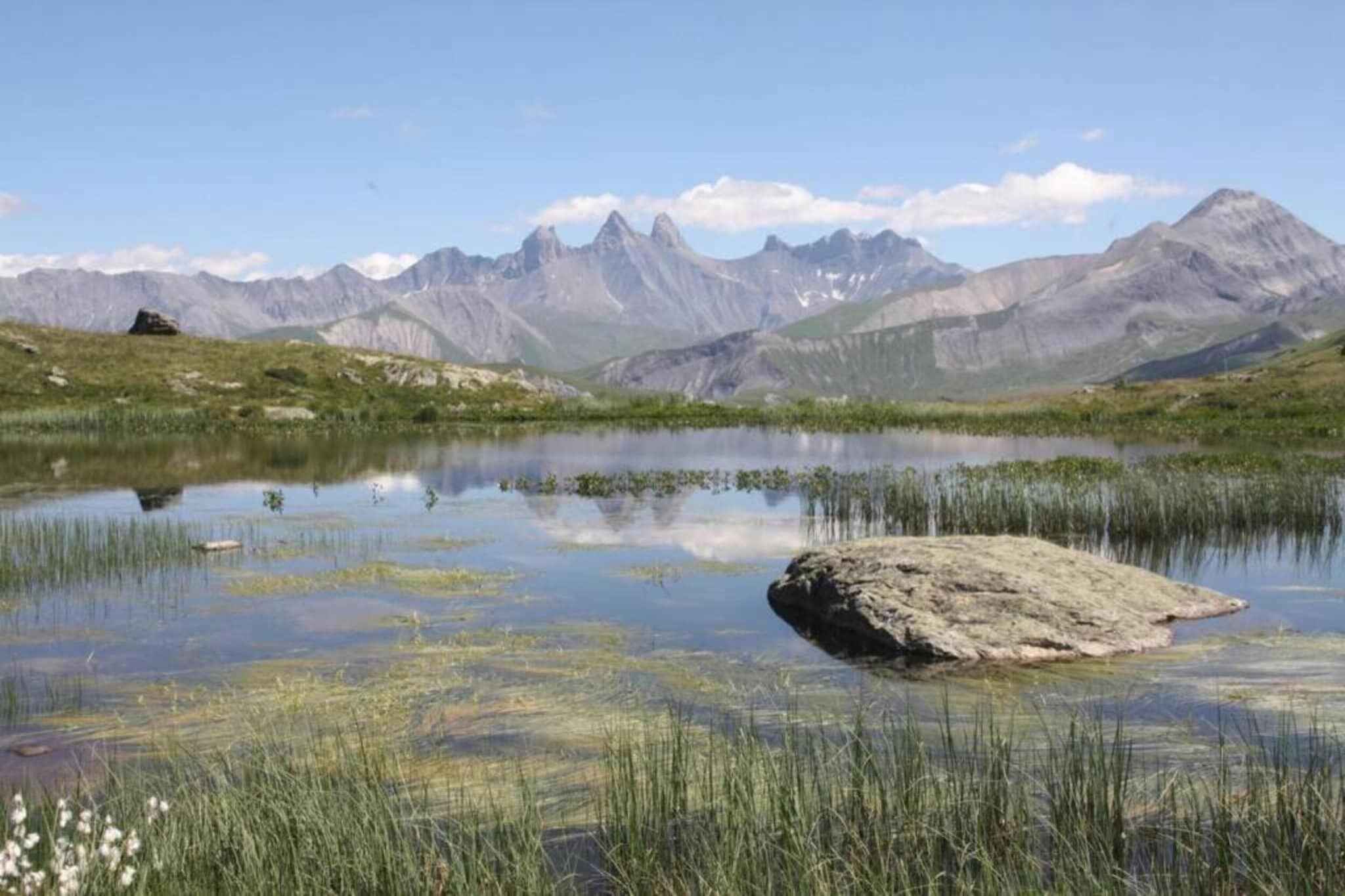 A tranquil lake surrounded by mountains.