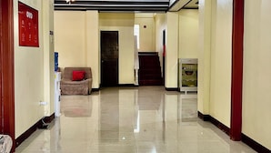A spacious lobby with a high ceiling, a ceiling fan, and a polished tiled floor. - South Villa Apartelle Panglao Bohol (Panglao)