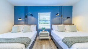 A room with two beds, a window with blinds, a bedside table with a plant, and two wall-mounted lamps. - 8Guest, 5 minutes to everything in Miami (Miami)