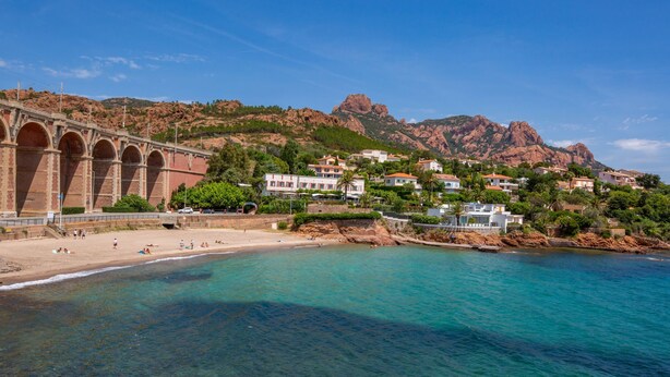 A coastal town with a bridge, clear turquoise waters, and houses with red roofs. - Boudi..ou by Interhome (Anthéor)