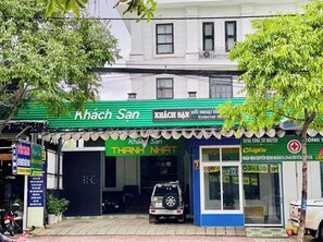 Stylish two-story building with a green awning and a blue and white facade.