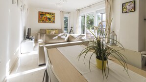 A modern living room with a sofa, a coffee table, and a potted plant. - COLL GROC - Nice villa with shared swimming pool in Grau i Platja (Gandia)