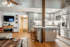 A modern kitchen with grey cabinets, stainless steel appliances, and a central island. - Sunshine Village #108- 1 +Loft , Sleeps 6.  Steps from Free Town Shuttle ,Dog Friendly (Mammoth Lakes)
