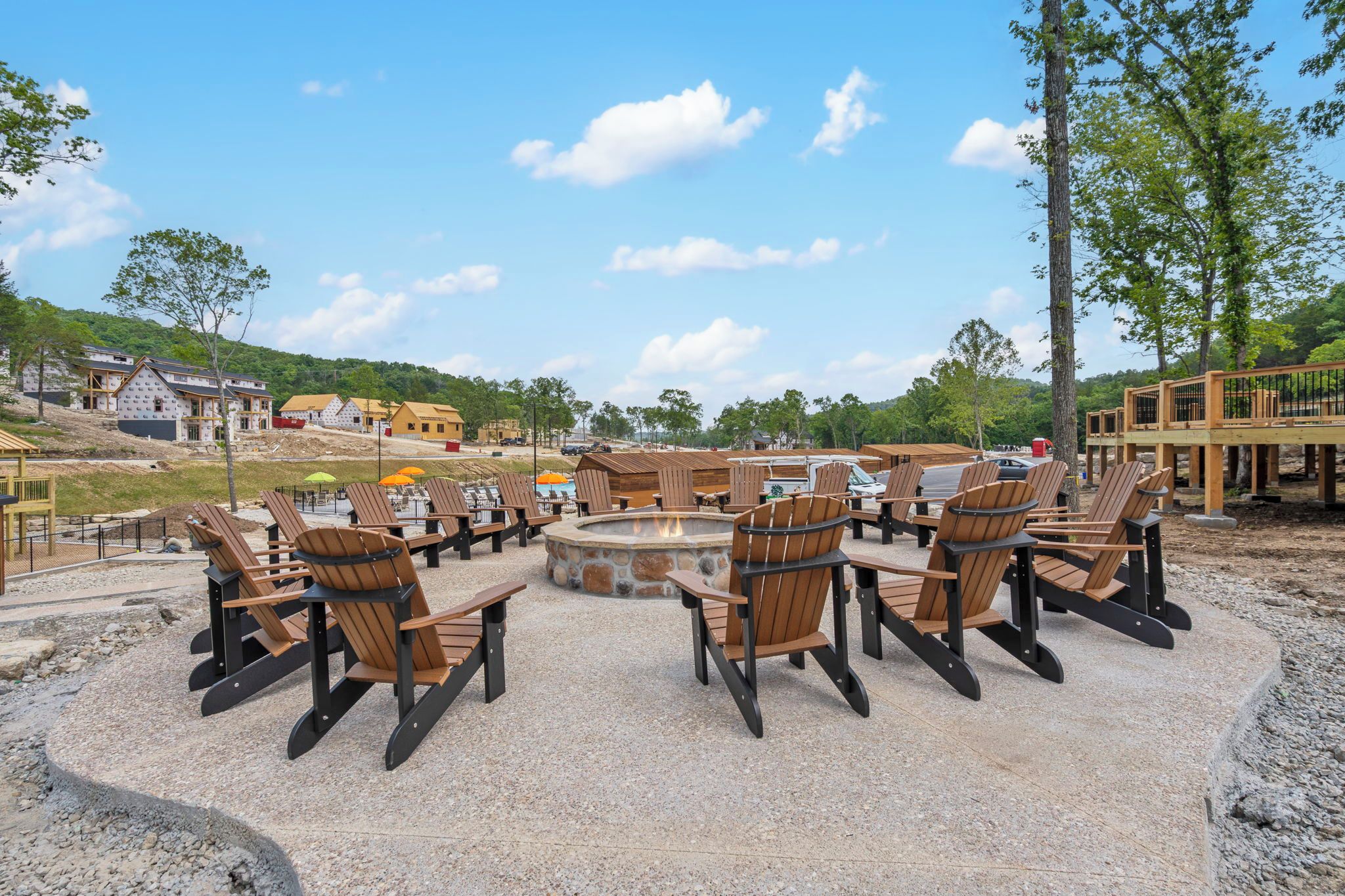 A circular seating area with chairs and a fire pit, surrounded by a gravel path.