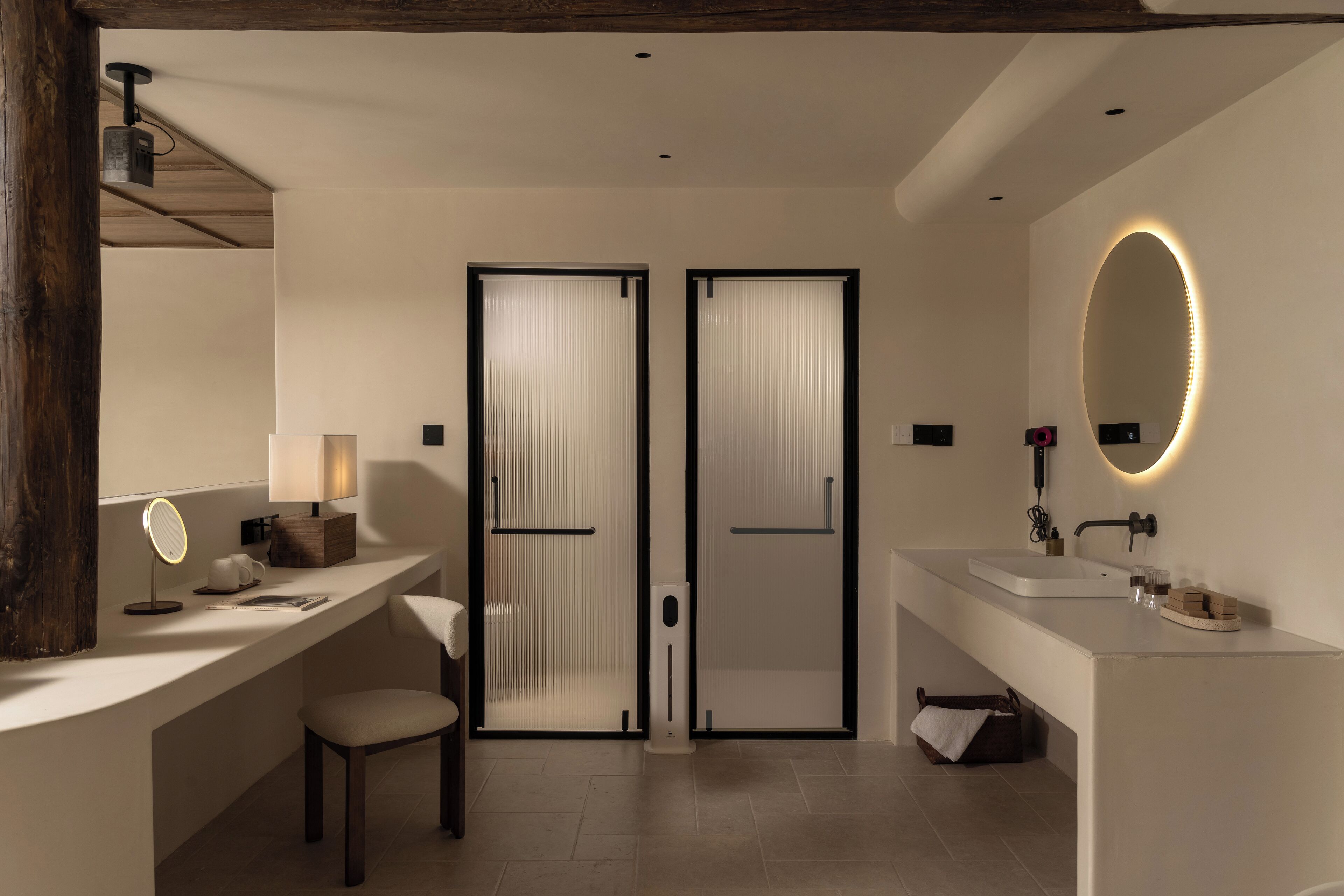 A modern bathroom with a vanity, a mirror, and a toilet.