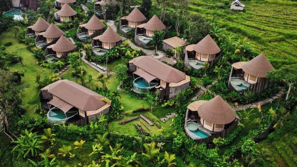 A resort with thatched-roof bungalows, private pools, and lush greenery. - The Wapa Lux Tent (Sidemen)