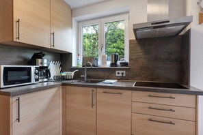 Een koelkast, een magnetron, een kookplaat, een vaatwasser