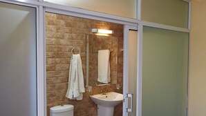 A bathroom with a toilet, sink, and shower. - JKIA Boutique Inn (Syokimau)
