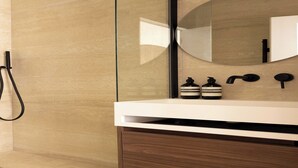 A modern bathroom with a wooden vanity, a large mirror, and two bottles of soap. - Charming Studio - 2P- Madeleine (Paris)