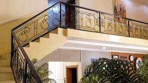 A staircase with ornate metal railings leading to an upper floor. - Dreamland suites (Abuja)