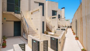 A modern urban building with multiple balconies, staircases, and potted plants. - A. Mirador Blue K Cala Sant Vicenç (Cala Sant Vicenç)