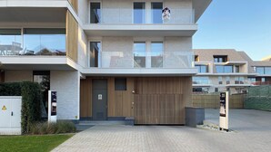 A modern multi-story residential building with a gated entrance, a visible mailbox, and a sign indicating the property number 35. - Apartment Near Marina Nieuwpoort & Pool (Nieuwpoort)