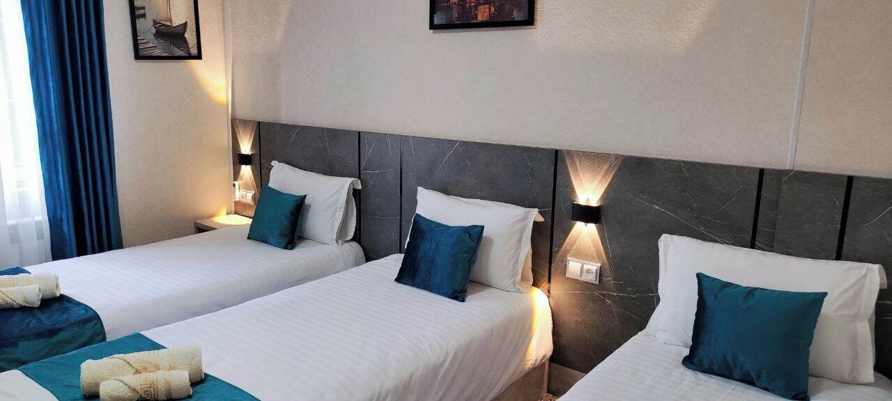 Standard Triple Room | Desk, laptop workspace, blackout drapes, iron/ironing board