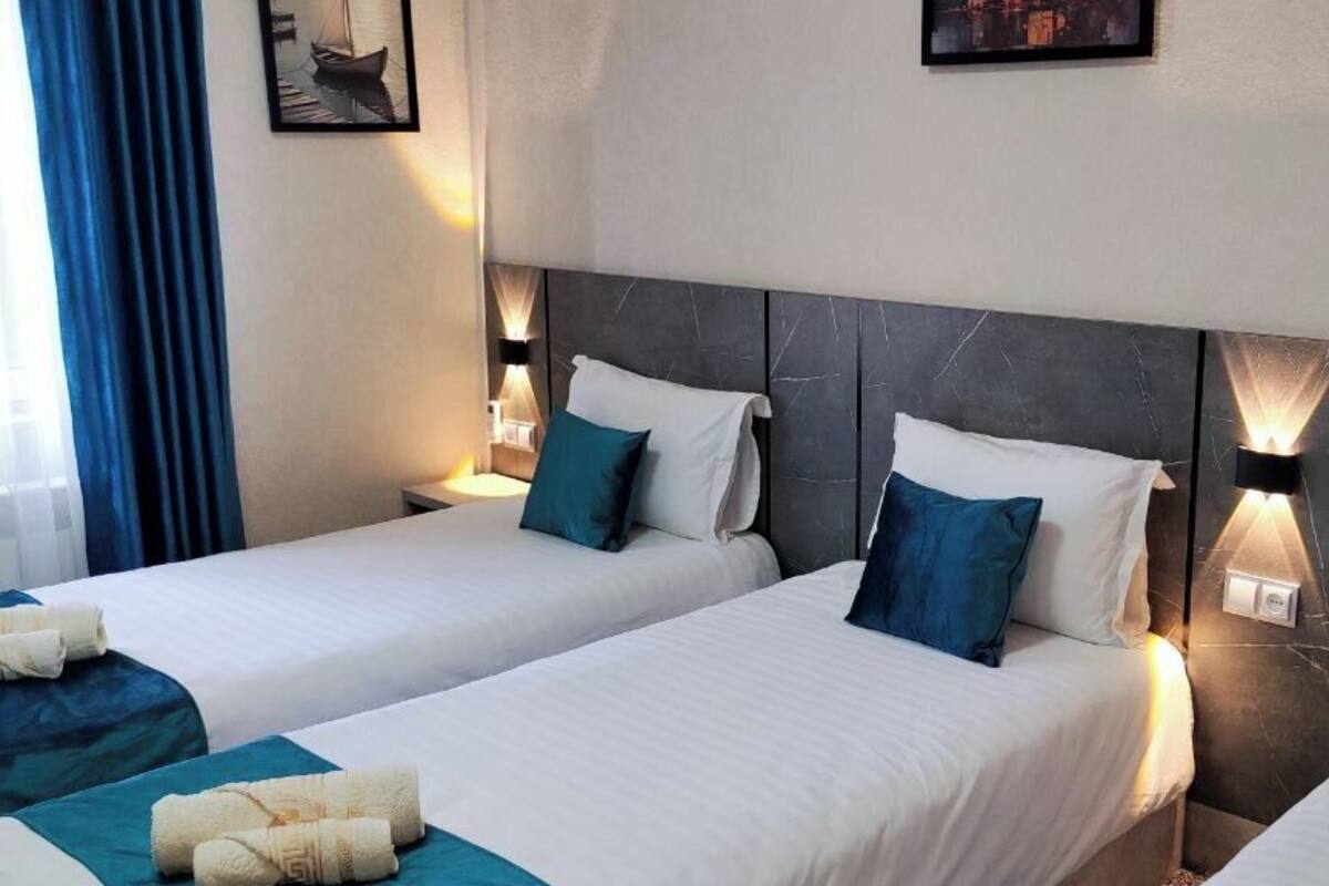 Standard Triple Room | Desk, laptop workspace, blackout drapes, iron/ironing board