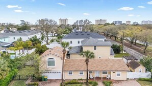A residential area with multiple houses, a paved road, and trees. - Sunshine Hideaway - Team Joseph Ellen (Jacksonville Beach)