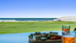 A beach view with a table, a bench, and a fence. - Absolute Beachfront Apartment 3B (Lennox Head)