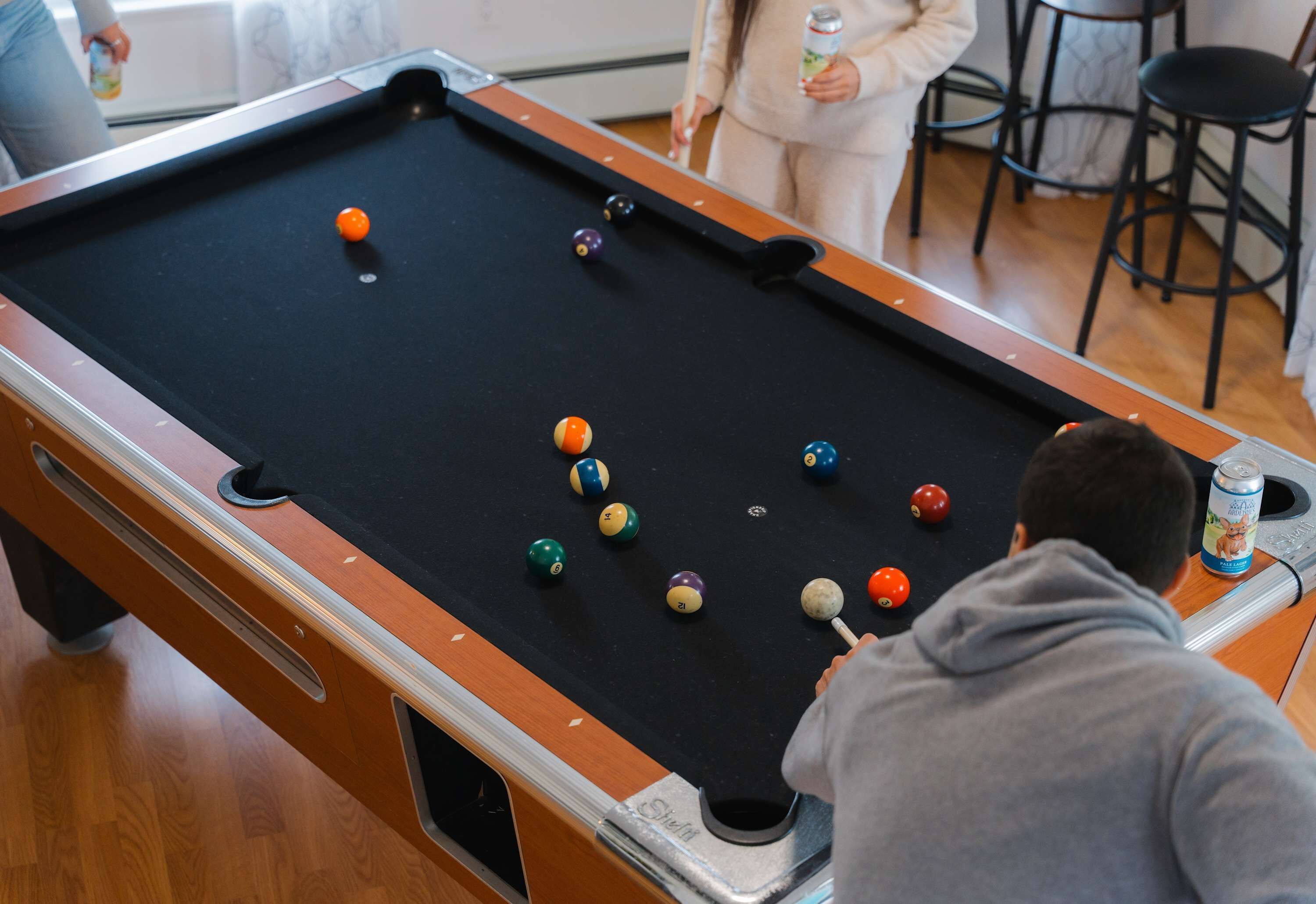 A pool table with balls in a casual indoor setting.